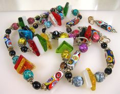 "Beautiful Murano Venice Memphis Style Glass Bead Necklace and Clip Earrings Set. The necklace is 34\" Long. The finding are silver plated. The dangle clip earrings are 2\" L.  This excellent set has every imaginable .. bead and findings." Retro Colorful Beads Jewelry For Making, Retro Colorful Beads Jewelry For Jewelry Making, Retro Beaded Dangle Jewelry, Murano Venice, Puka Shell Necklace, Shell Choker, Memphis Style, Bone Pendant, Puka Shell