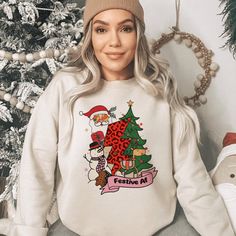 Embrace the yuletide spirit with our 'Whimsical Festive AF' holiday sweatshirt! Featuring playful Santa, snowman, and leopard-print tree graphics, this cozy sweatshirt is your perfect companion for cheerful winter days. Available in various colors and sizes exclusively on our website. Lovingly crafted by our dedicated small business, bringing you comfort and festive vibes all season long. **Product Details - Unisex, crewneck sweatshirt - 50/50 cotton and polyester - For best fit and color choice Christmas Graphic Print Relaxed Fit Sweatshirt, Holiday Graphic Print Sweater, Holiday Graphic Print Cotton Sweatshirt, Relaxed Fit Christmas Sweater With Graphic Print, Holiday Graphic Print Sweatshirt, Christmas Sweater With Graphic Print And Relaxed Fit, Holiday Cotton Sweatshirt With Graphic Print, Holiday Sweatshirt With Graphic Print, Relaxed Fit Holiday Sweatshirt For Fall