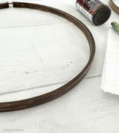 a white table with some paint and other items on it, including an empty bottle