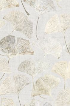 a white and beige wallpaper with leaves in the middle, on top of it