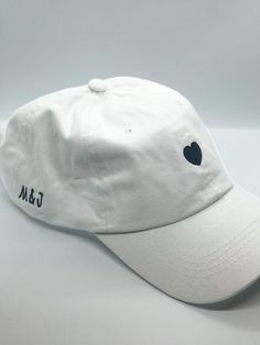 White or black, adjustable baseball cap perfect for an engagement gift, a bridal shower, or bachelorette party. Customizable first name initials on the side of the cap. Use promo code SAVEHATS to save 10% on 5 or more hats! Please note- all custom hats require at MOST 14 days to process, as each hat is made to order. This does not include shipping time. Based on the volume of orders at the time, this processing time may be shortened! If you are working on a timeline, be sure to message me so we Wedding Baseball Hat, Bach Gifts, Bach Gift, Cap Code, White Baseball Hat, Custom Baseball Hats, Bachelorette Hats, Bff Gifts Diy, White Baseball Cap