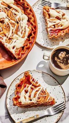 two plates with slices of pie on them next to a cup of coffee