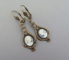 Blue White Cameo Dangle Earrings!  Take yourself back in time with these wonderful Vintage Style dangle earrings... Art Nouveau style earrings Antiqued Gold Brass with dainty Light Blue and White cameos. Dainty flowers decorate these drop earrings.  10x8mm cabochons.  Dangle 1" below the  nickel free ear wires. Storefront and Sections: hawaiibeads.etsy.com 82BBE Cottagecore Earrings, Dainty Flowers, Cameo Earrings, Earrings Art, Art Nouveau Style, Antique Earrings, Gold Brass, Style Earrings, Ear Wires