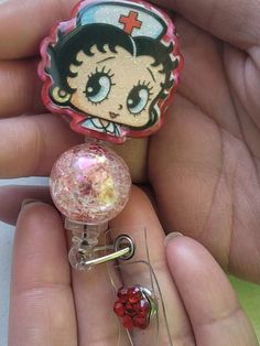 Betty Boop in her iconic nursing attire, these retractable ID badge reels add a dash of charm and personality to your workday Retractable ALLIGATOR TYPE clip. The nature of the epoxy resin crafting process may result in SMALL BUBBLES and BUMPS, adding to the charm and uniqueness of the badge reel. **CANCELLATION accepted within 24 hours, unfortunately I can not accept REFUNDS or EXCHANGES but please contact me for any concerns with order. Pink Badge Holder With Swivel Clip As Gift, Pink Badge Reel With Swivel Clip As Gift, Customizable Red Badge Reel As A Gift, Novelty Adjustable Badge Holders For Gifts, Novelty Adjustable Badge Holders For Gift, Novelty Pink Badge Reel, Handmade Novelty Pink Badge Reel, Beautiful Beaded Necklaces, Funny Nurse