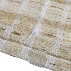 a close up view of woven material on a tablecloth with white thread and glass beading