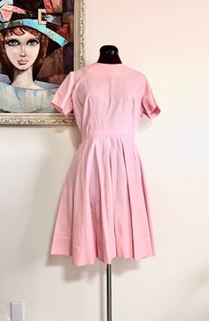 "Adorable 60s pink pleated knee length dress, by Kabro of Houston. It has a crew neckline, short sleeves and a detatchable belt, the skirt is pleated. Such a darling dress!  Material: Cotton Color/print: Pink Maker: Kabro of Houston Origin: US  Era: 50's/60's Size: M Measurements Bust- 39\"  Sleeve Length- 7\" Waist- 28\"  Hips- 71\" fully extended  Length- 36.5\" Condition: very good, pre-owned, the underarms have been crudely mended at seam Bust-taken from under the arm to under arm laying flat Sleeves-taken from under the arm to sleeve end Waist-taken from side to side laying flat Length-taken from shoulder to hem laying flat" Pink Dress With Fitted Waist And Short Sleeves, Pink Belted Short Sleeve Dress, Classic Short Sleeve Dress With Pleated Skirt, Pink Short Sleeve Dress With Pleated Waist, Retro Dresses With Pleated Waist For Daywear, Fitted Short Sleeve Dress With Accordion Pleats, Fitted Short Sleeve Dresses With Pintucks, Spring Knee-length Pleated Vintage Dress, Spring Pleated Knee-length Vintage Dress