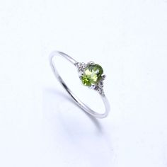 RING DETAIL Metal : 925 sterling silver Center stone : Peridot & cubic zirconia Shape : Oval Stone size; 6x4mm CUBIC ZIRCONIA We just utilize the best cubic zirconia. With shading, lucidity and phenomenal slice to coordinate common precious stone guidelines, our fine quality cubic zirconia gives the ideal degree of brightness, sparkle and fire. PERIDOT Peridot stones are birthstones for August, September and October... furthermore, make lovely valuable jewelry.Using Peridot gemstones Peridot wil Green Sterling Silver Crystal Promise Ring, Peridot Birthstone Ring In White Gold, Green Crystal Birthstone Ring In Sterling Silver, Green Sterling Silver Diamond Promise Ring, Silver Peridot Birthstone Ring, Silver Peridot Ring With Birthstone, Silver Ring With Peridot Birthstone, Silver Peridot Solitaire Ring, Silver Peridot Promise Ring