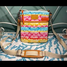 “Hamptons Weekend Collection” Great Crossbody For The Summer! New With Tags. Top Zip, Adjustable Strap, Outside Pocket On Both Sides. Summer Colors: Aqua, Pink And Yellow. Outside Slip Pocket On Front And Back. Great For Keys And Phone. Measures: 8 1/2”H X 7 1/4”W X1/2” D Item Is Being Sold “As Is”. See All Photos For Condition And Detail On Actual Pocketbook That You Will Receive. Check Back For More Spring/ Summer Bags To Be Listed. Designer Multicolor Bag With Adjustable Strap, Designer Multicolor Shoulder Bag With Adjustable Strap, Designer Multicolor Bags With Adjustable Strap, Multicolor Rectangular Coach Shoulder Bag, Coach Multicolor Rectangular Bag, Multicolor Rectangular Coach Bags, Multicolor Coach Pouch Bag, Multicolor Retro Coach Bag, Multicolor Coach Bag With Zipper Closure