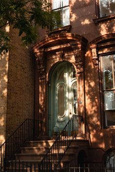 an old building with stairs leading up to the front door