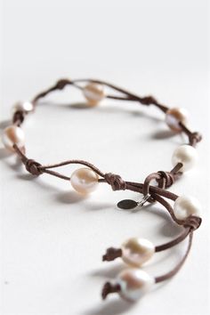 Authentic boho style with a twist! Our 9 Fresh Water Pearl Wrap features nine white freshwater pearls set in a beautiful brandy-colored leather with pearl sizes varying from 6 - 14mm. This chic jewelry was featured in Accesories Magazine as the Best Friendship Bracelet and, just like a good friend, is a rare find. Wrap twice to wear it as a bracelet or fully extend to wear as a choker, as it is 19" long at its longest point. Choker length is adjustable from 15"-19". Wrap Armband, Bracelet Cordon, Pola Gelang, Handmade Wire Jewelry, Homemade Jewelry, A Bracelet, Chic Jewelry, Bracelet Crafts, Bead Jewellery