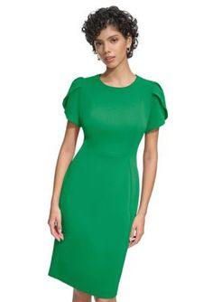 Sharp enough for formal occasions and stylish enough for smaller events, this solid dress from Calvin Klein is updated with short tulip sleeves for a flattering look. | Calvin Klein Women's Solid Sheath Dress, 6 Solid Short Sleeve Bodycon Dress For Formal Occasions, Fitted Cap Sleeve Midi Dress For Formal Occasions, Fitted Flutter Sleeve Midi Dress For Evening, Elegant Green Midi Dress With Flutter Sleeves, Fitted Office Dress With Pleated Sleeves, Solid Color Short Sleeve Bodycon Evening Dress, Short Sleeve Bodycon Dress For Evening, Fitted Midi Dress With Flutter Sleeves For Evening, Structured Short Sleeve Spring Dress