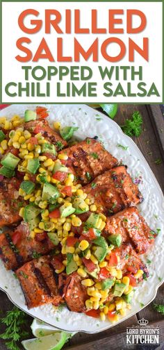 grilled salmon topped with corn and avocado salsa on a white platter