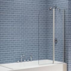 a bath tub sitting next to a blue brick wall