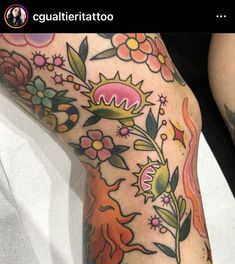 a woman's leg with flowers and leaves on it