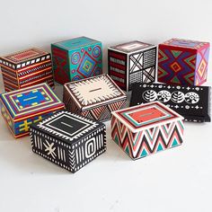 a group of colorful boxes sitting on top of a white table next to each other