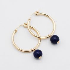 Add a subtle touch of navy to your favorite Jewel Ya hoops! Hand wired midnight blue navy quartz hoop drops. Your choice of sterling silver or 14k gold filled wire. Drops are designed to fit both the endless and tube hoop styles. Every Jewel Ya design arrives in our signature acrylic container for airtight storage. Blue 14k Gold Filled Hoop Jewelry, Blue Nickel-free 14k Gold-filled Hoop Earrings, Blue Wire Wrapped Hoop Earrings For Everyday, Everyday Blue Wire Wrapped Hoop Earrings, Acrylic Containers, Airtight Storage, Jewelry Case, Midnight Blue, Gold Filled