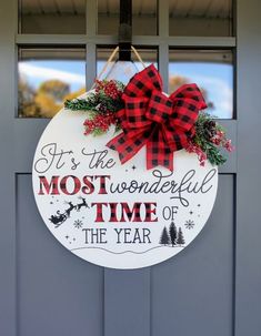 a sign that says it's the most wonderful time of the year hanging on a door