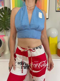 "Deadstock 1970s light blue chambray halter top Lined bodice Ties in back Cotton blend Est to fit an A - B cup best but go by measurements below for best fit. Buyer is responsible for confirming fit and sales are final. Please reach out with any questions!  CONDITION: new w/ tags - has been in storage since the 70s so may have a light mark or two MEASUREMENTS (taken laying flat then doubled where applicable:) 16-17\" long  up to 31\" underbust 13\" under cups only 8\" cup width  Model is 34B wit Fitted Halter Neck Crop Top For Day Out, Trendy Fitted Halter Top For Summer, Fitted Summer Halter Top For Day Out, Chic Cropped Halter Top For Summer, Fitted Halter Top For Summer Day Out, Trendy Cotton Halter Top For Day Out, Retro Cotton Tank Top For Summer, Retro Summer Cotton Tank Top, Retro Cotton Summer Tops