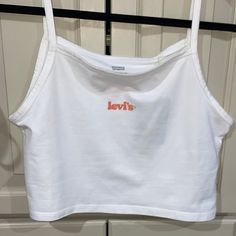 Brand New Never Worn Levi’s Tank Top. Crop Top. White. Size Small! Levi On Front! Flower On Back! Trendy Levi's Summer Tops, Summer Trendy Levi's Tops, Levi's White Cotton Top, Levi's Cotton Tops For Spring, White Cotton Levi's Top, Belly Top, Pride Tank Tops, Tank Top Crop Top, American Flag Tank Top