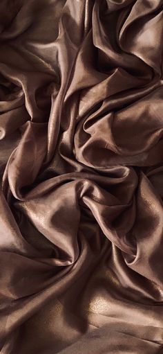 the fabric is shiny and brown in color