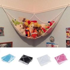 several stuffed animals in a hammock hanging on the wall