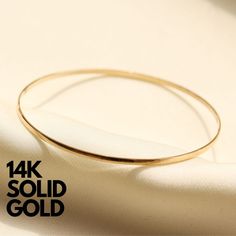 Our 14K Gold Bangle bracelet is made with genuine 14K solid gold and is an heirloom piece that will last you a lifetime. The perfect gold bracelet staple to add to your stack.  D E T A I L S * Gold KT: 14K Solid Gold * Gold Color: Yellow Gold * Chain Lengths: 7", 7.5", 8" * Chain Width: 2mm * Chain Style: Bangle S H I P P I N G & R E T U R N S * Ready to Ship in 1-2 Business Days * FREE shipping on all U.S. orders  * Easy 30 day returns, just contact us! * Packed in labeled gift box C O N T A C 14k Yellow Gold Tarnish-resistant Bangle, Fine Jewelry 14k Stamped Bangle, Heirloom 14k Gold Round Bracelets, Heirloom 14k Gold Bracelets, 14k Gold Heirloom Bangle Cuff Bracelet, Heirloom 14k Gold Cuff Bangle Bracelet, Heirloom 14k Gold Bangle Cuff Bracelet, 14k Gold Stamped Bangle Bracelet, 14k Gold Bangle Bracelet With Polished Finish