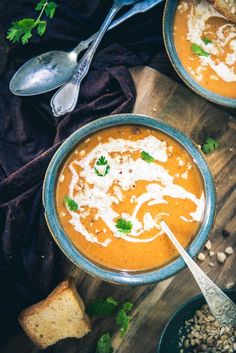 two bowls of soup with bread and parsley