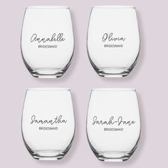 four wine glasses with the names of bridesmaid and groomsmid written on them