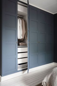 a bedroom with blue cabinets and white walls