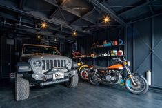 two motorcycles and a jeep in a garage