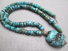 "A beautiful Southwestern hand crafted genuine turquoise necklace. Handsome heishi shaped turquoise beads form the 18\" long necklace....gorgeous blues with hints of green and chocolate color matrix. I know all you women will love this one, but it's perfect for a guy too! The heishi are about 9mm wide, with an outrageous large blue turquoise stone hanging from the center. The colors are wonderful, like that of the famous Kingman Mine. A beautiful piece, one with which you'll receive many a compl J Necklace, Jewelry Turquoise, Necklace Tutorial, Real Turquoise, Southwestern Jewelry, Chocolate Color, Jewelry Armoire, Blue Gems, Crown Jewels