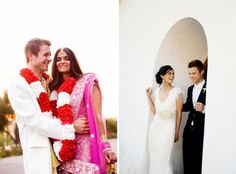 a couple standing next to each other in front of a white wall with red flowers