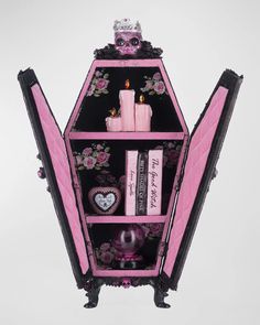 a pink and black shelf with candles on it