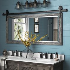 a bathroom with two sinks and a large mirror on the wall above it is shown