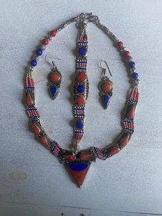 (MARKED DOWN FROM $125)  This is a gorgeous jewelry set: Necklace, Bracelet, Dangle Hook Earrings.  This set is truly one of a kind (vintage) with multi colors in the pieces (as seen in photo). NECKLACE Length: 18" inches Main Stone: Lapis Lazuli Main Shell: Red Coral; Spinny Oyster Metal: Silver Plate; Tibetan Silver Main Colors: Red, Blue, Orange, Silver BRACELET Length: 7.5" inches  Main Stone: Blue Turquoise Main Shell: Red Coral Metal: Silver Plate; Tibetan Silver Main Colors: Blue, Red, Si Tibetan Jewelry The Little Tibet, Tibetan Earrings, Tibetan Necklace, Tibetan Bracelet, Tibetan Jewelry, Wedding Jewellery, Gorgeous Jewelry, Wedding Jewelry Sets, Red Coral