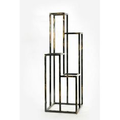 three black and gold metal shelvings stacked on top of each other in the shape of cubes