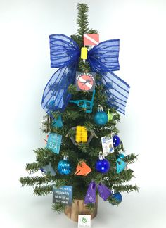 a small christmas tree with blue bows and decorations