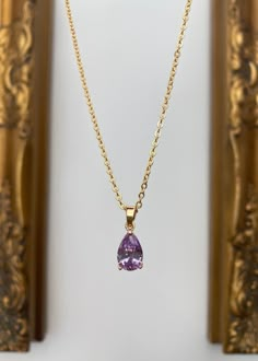 Gold-plated lilac teardrop jewel necklace. The blue teardrop jewel is set in a gold-plated frame measuring 1.2 cm x 0.8 cm. Hung on a gold-plated chain which measures 45.7 cm (18 inches). Comes in a black velvet cushioned box as seen in last photo. Free of charge. Matching earrings available here.... https://www.etsy.com/uk/listing/961868771/lilac-teardrop-jewel-huggie-hoop?ref=listing_published_alert INTERNATIONAL BUYERS please choose the tracking option if you would like your order to be track Gold Pear-shaped Drop Necklace With Gemstone, Elegant Lavender Drop Necklaces, Elegant Lavender Teardrop Necklace, Lilac Necklace, Lilac Jewelry, Gold Necklace Wedding, Asymmetrical Earrings, Jewel Necklace, Gem Necklace