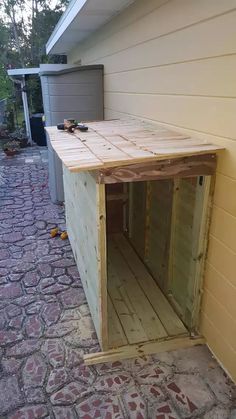 a dog house built into the side of a building that is being built with wood