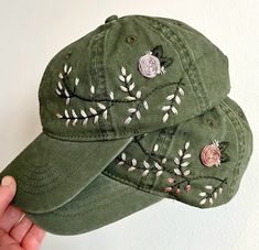 Hand embroidered green hat with floral design spread across left or right side of hat. Adjustable strap to fit all sizes with ponytail opening in back. Hand wash to preserve quality. Embroidered Short Brim Baseball Cap, Adjustable Green Hat With Embroidered Logo, Green Adjustable Brimmed Baseball Cap, Green Hats With Embroidered Logo, One Size, Green Hats With Embroidered Logo, Adjustable Embroidered Green Hats, Green Embroidered Baseball Cap With Curved Brim, Green Embroidered Adjustable Hat, Green Brimmed Baseball Cap