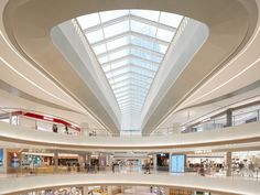 the inside of a shopping mall with people walking around