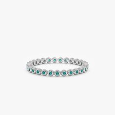 Nyra Timeless, elegant & dainty, this rich shade of green will make you feel like royalty each time you gaze at your hand! This can be your vibrant and unique wedding band, yet also the perfect dainty ring to add a pop of color to your solid gold ring stack. This is a full eternity band surrounding the entire finger. Choose your metal and size, and we will make it custom for you. May’s birthstone, this is a stunning ring to stack with your wife’s wedding ring! - Handmade- Solid Gold- Natural Eme Elegant Stackable Emerald-cut Eternity Band, Elegant Jewelry With Halo Design And Round Band, Timeless Green Round Band Jewelry, White Gold Emerald-cut Stackable Eternity Band, White Gold Emerald Cut Stackable Eternity Band, Elegant Eternity Band With Halo Design, Elegant Round Emerald Ring With Halo Design, Elegant Halo Eternity Band, Timeless Green Jewelry With Bezel Setting