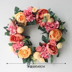 a floral wreath with pink and orange flowers