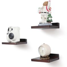 three shelves with various items on them including a camera, polar bear and snowman