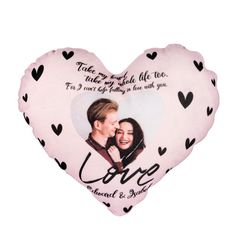 a heart shaped pillow with an image of two people on it and the words love