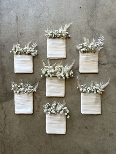 six white vases with flowers on them are arranged in the shape of rectangles