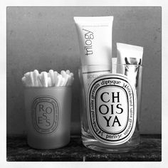 a couple of cups sitting on top of a counter next to some toothbrushes