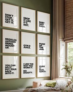 six black and white prints on the wall above a bed in a room with green walls