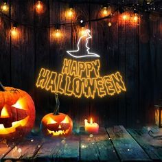 two jack o lantern pumpkins on a wooden table with lights around them and the words happy halloween