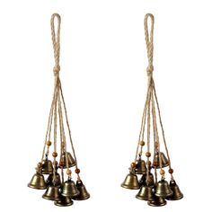 three bells hanging from rope on white background